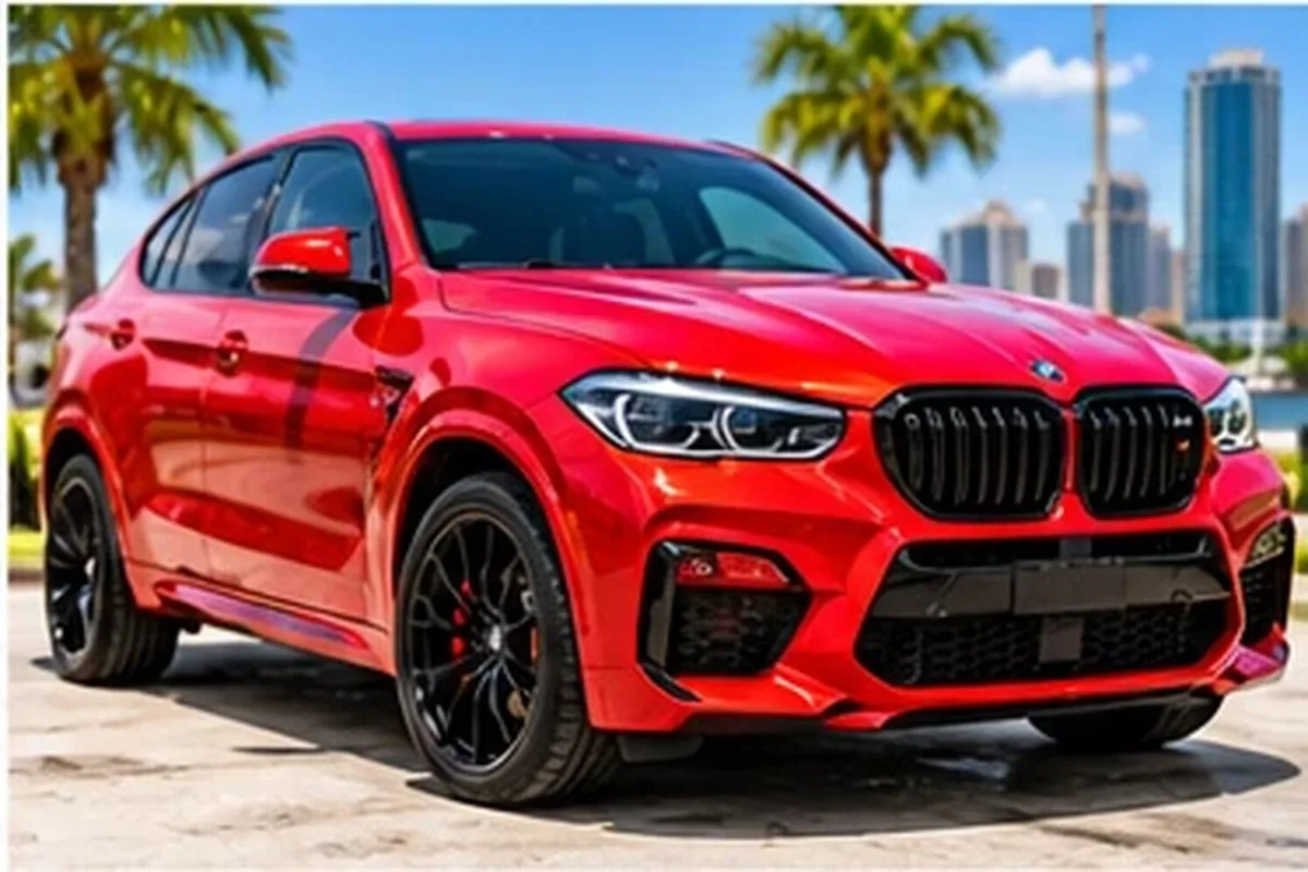 Red wrapped BMW luxury SUV with palm trees